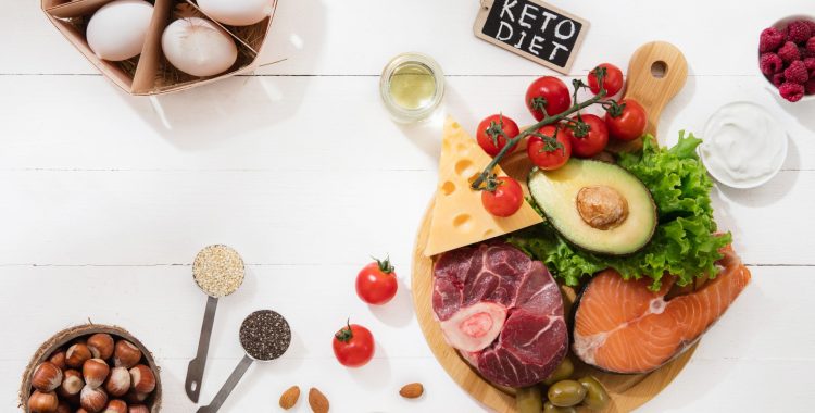 Ketogenic low carbs diet - food selection on white wooden background. Balanced healthy organic ingredients of high content of fats. Nutrition for the heart and blood vessels. Meat, fish and vegetables.