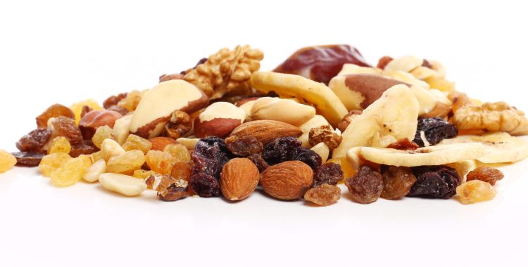 Different dried fruits against white background